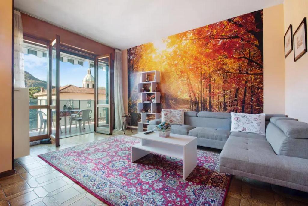 a living room with a large painting on the wall at Appartamento House of Roses con vista Duomo in Como