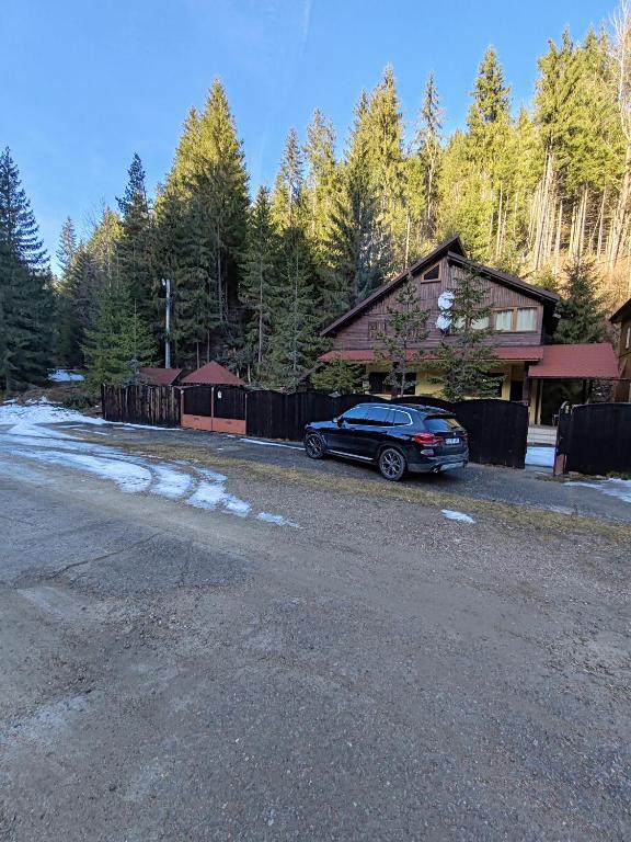 a car parked in front of a house at CEZARA Ski Lake View in Beliş