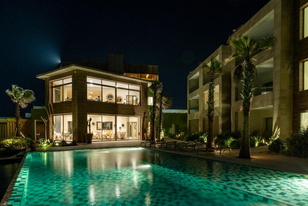 a swimming pool in front of a building at night at Dakhla South Bay in Dakhla