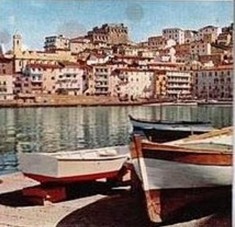 two boats are parked on the shore of the water at Frontemare in Porto Santo Stefano