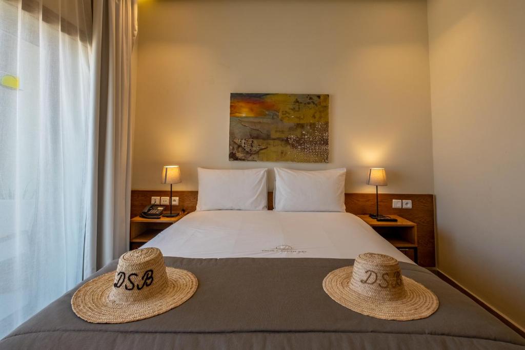 a bedroom with a bed with two hats on it at Dakhla South Bay in Dakhla