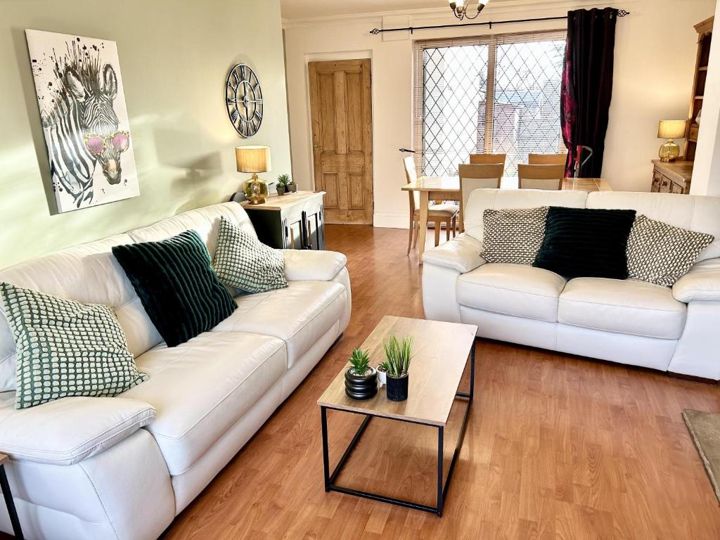 a living room with two white couches and a table at 6 Guests - 3 Bed House in Chester-le-Street in Chester-le-Street