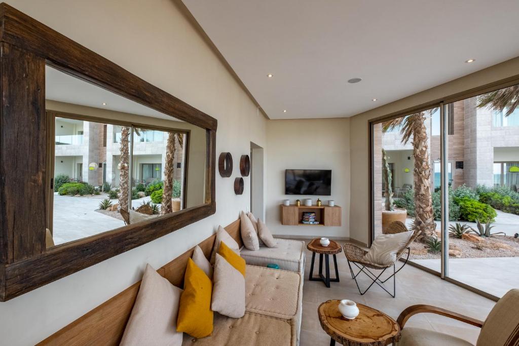 a living room with a couch and a large mirror at Dakhla South Bay in Dakhla