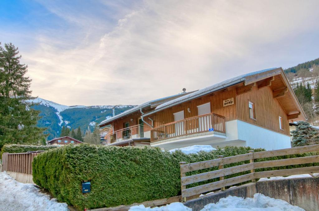 a log home in the mountains with snow at Haus Kemp in Zell am See
