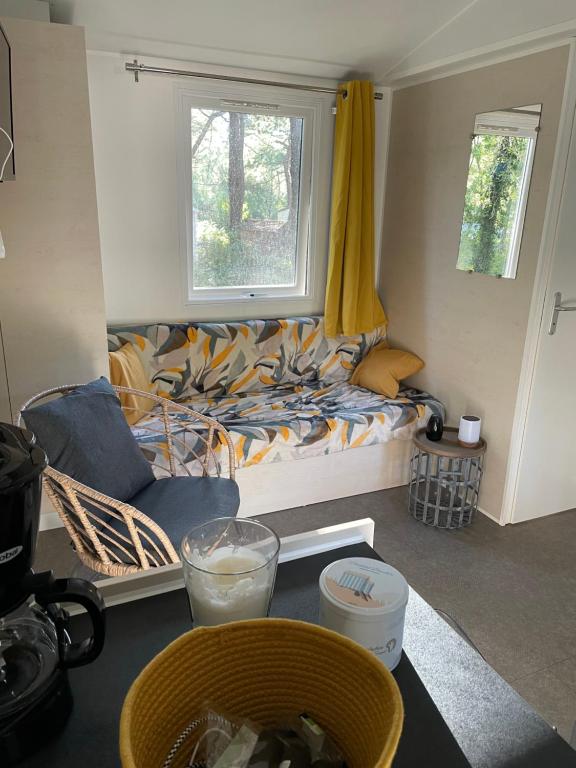 a living room with a couch and a window at Au petit paradis in Camiers