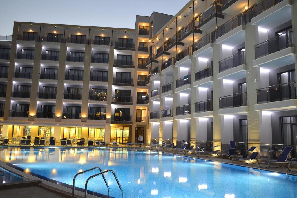 a hotel swimming pool in front of a building at Arena Mar Hotel and SPA in Golden Sands