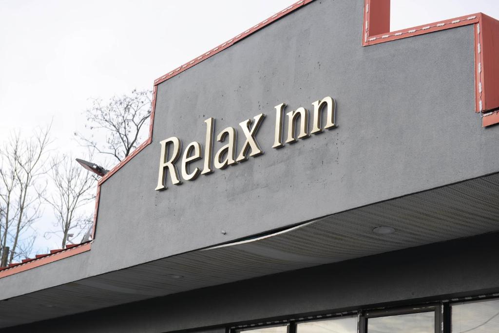 a sign on the top of a building at Relax Inn in Collinsville
