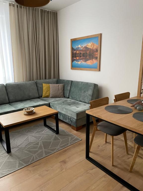 a living room with a couch and two tables at Apartmán Sirius in Vyšné Hágy