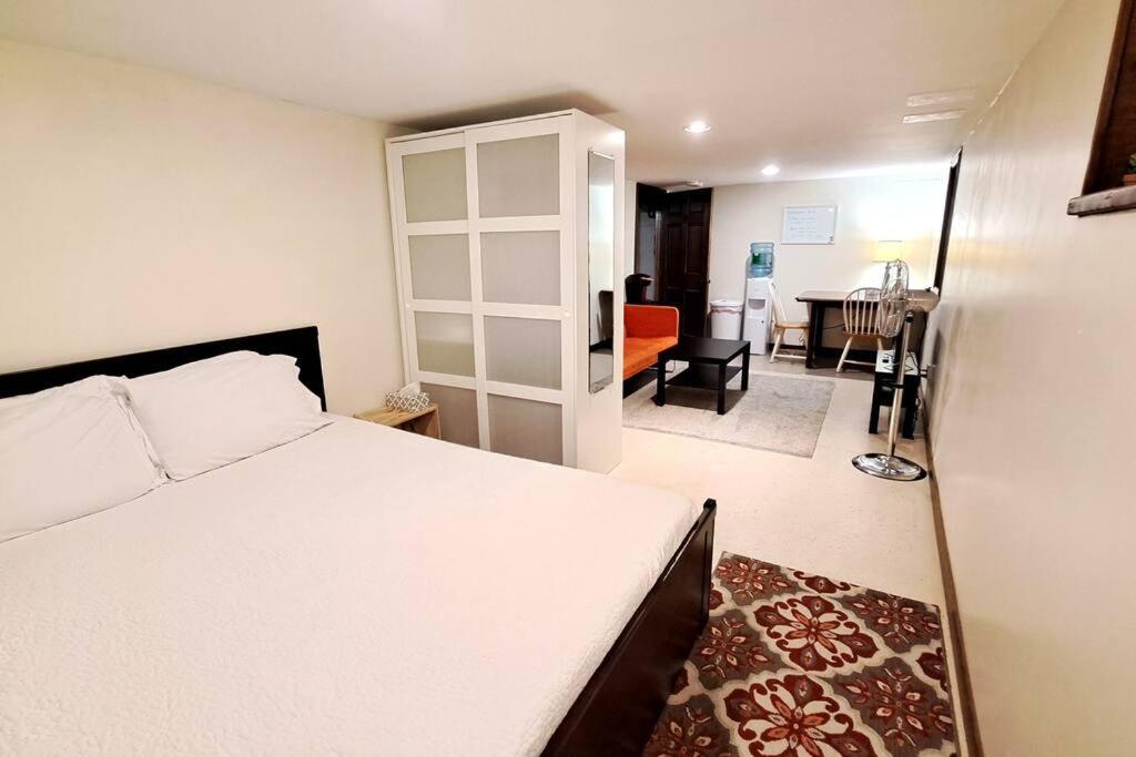 a bedroom with a bed and a living room at St Paul - Lower Level Apartment. Near downtown & Allianz stadium. in Saint Paul