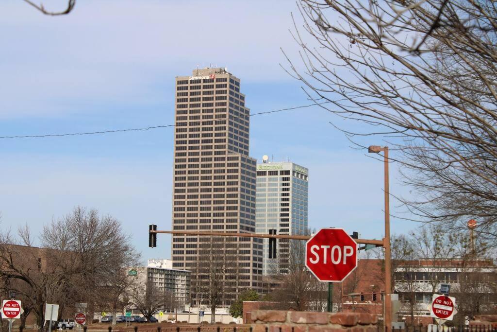a stop sign in front of a tall building at Downtown Condo in Little Rock