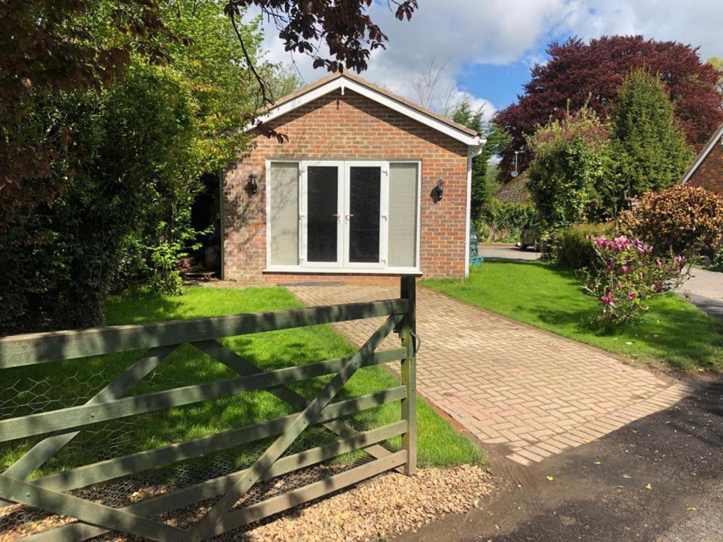 a brick house with a fence in front of it at Inviting 2-Bed fully Furnished House-High Wycombe in High Wycombe