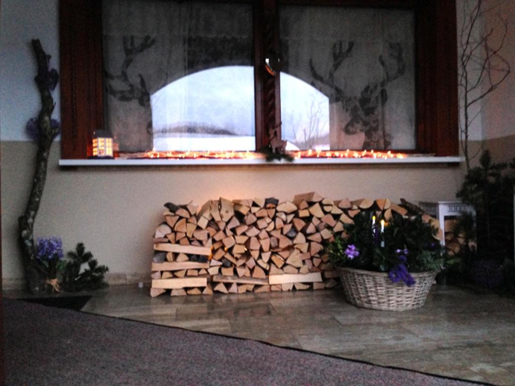 a pile of fire wood in a room with a window at Apartment am Wolfgangsee in Strobl