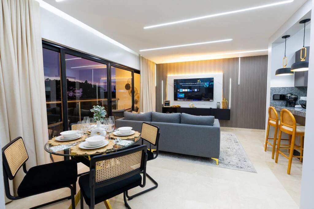 a living room with a table and a couch at Modern 2BR in La Trinitaria Sti No in Santiago de los Caballeros