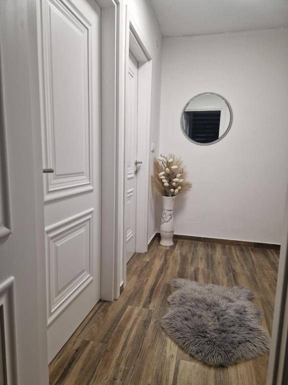 a hallway with a white door and a furry rug at Stan na dan Jelica Stanivuković in Šid