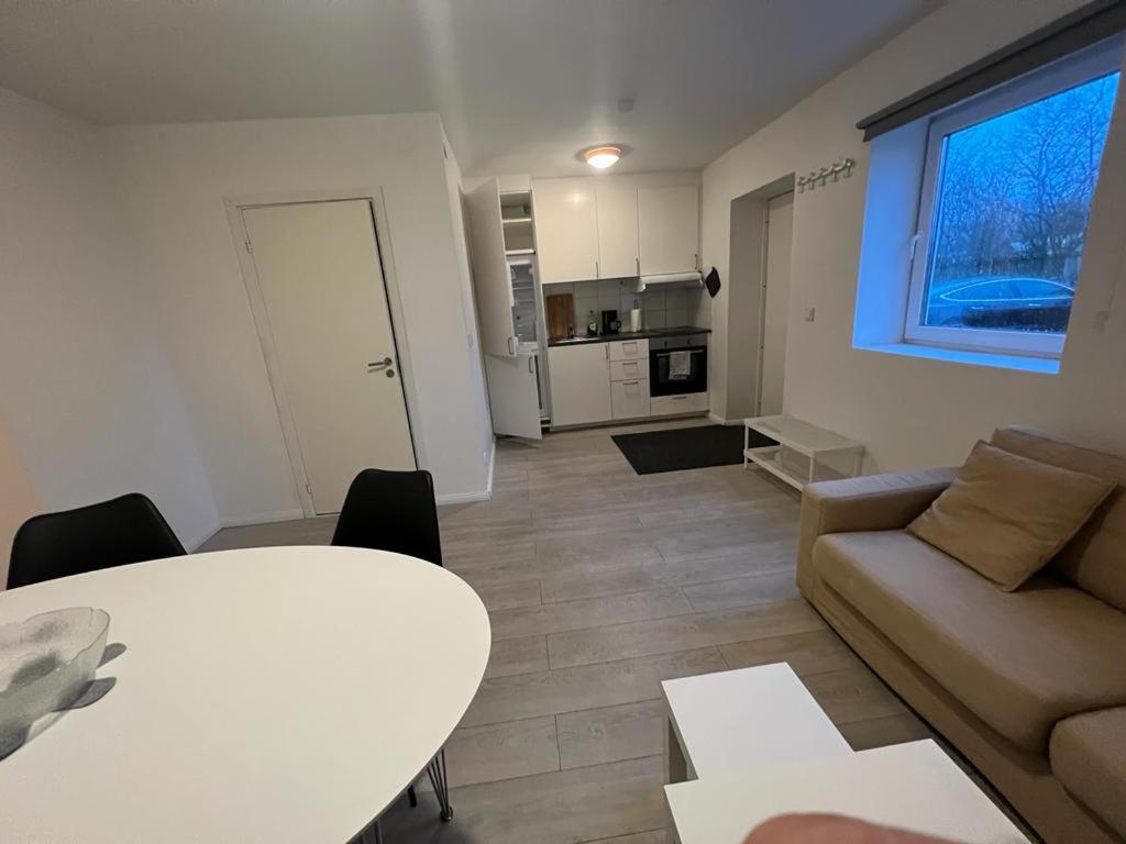 a living room with a table and a couch at New Two Bedroom Apartment Close To Beach in Abbekås