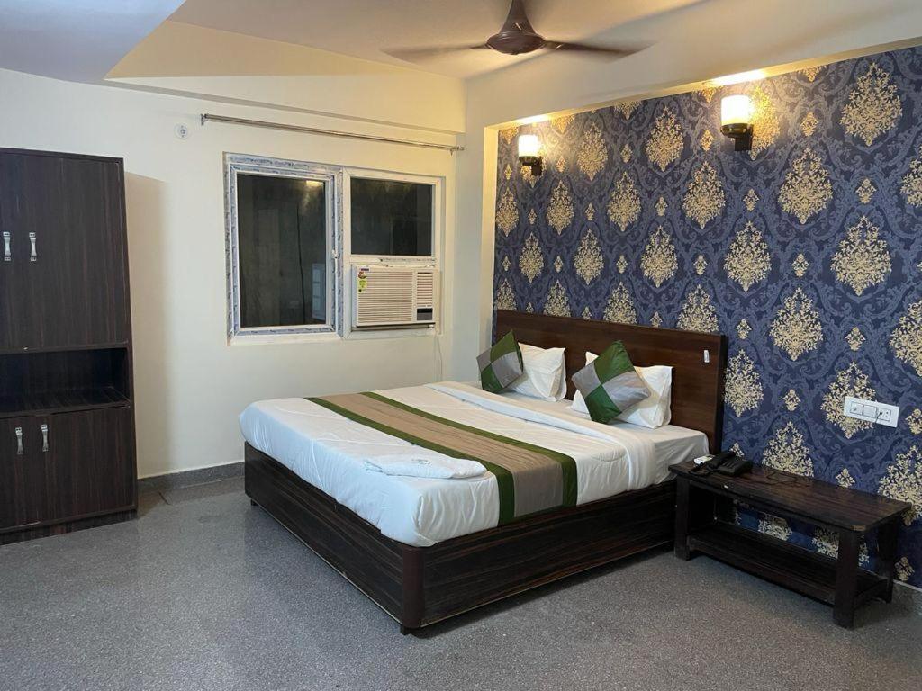 a bedroom with a large bed and a window at Hotel dream taj family rooms 200mtr from taj mahal in Agra