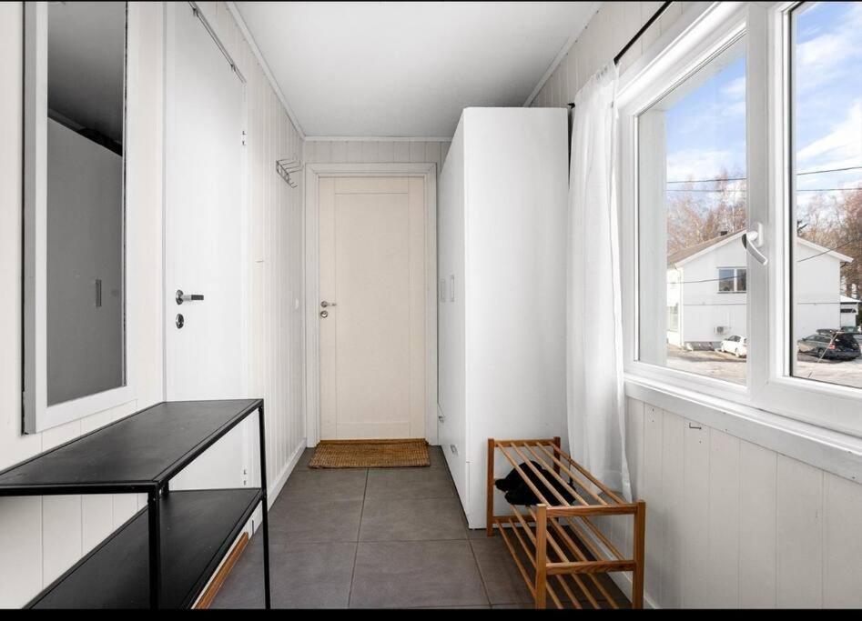 a room with a hallway with a window and a chair at Modern 2-bedroom apartment in Sand