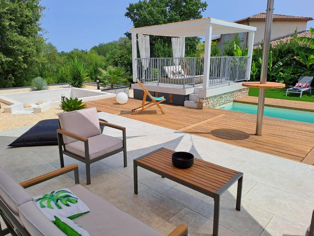 a patio with a gazebo and a pool at Ginatella - 3 chambres in Deaux