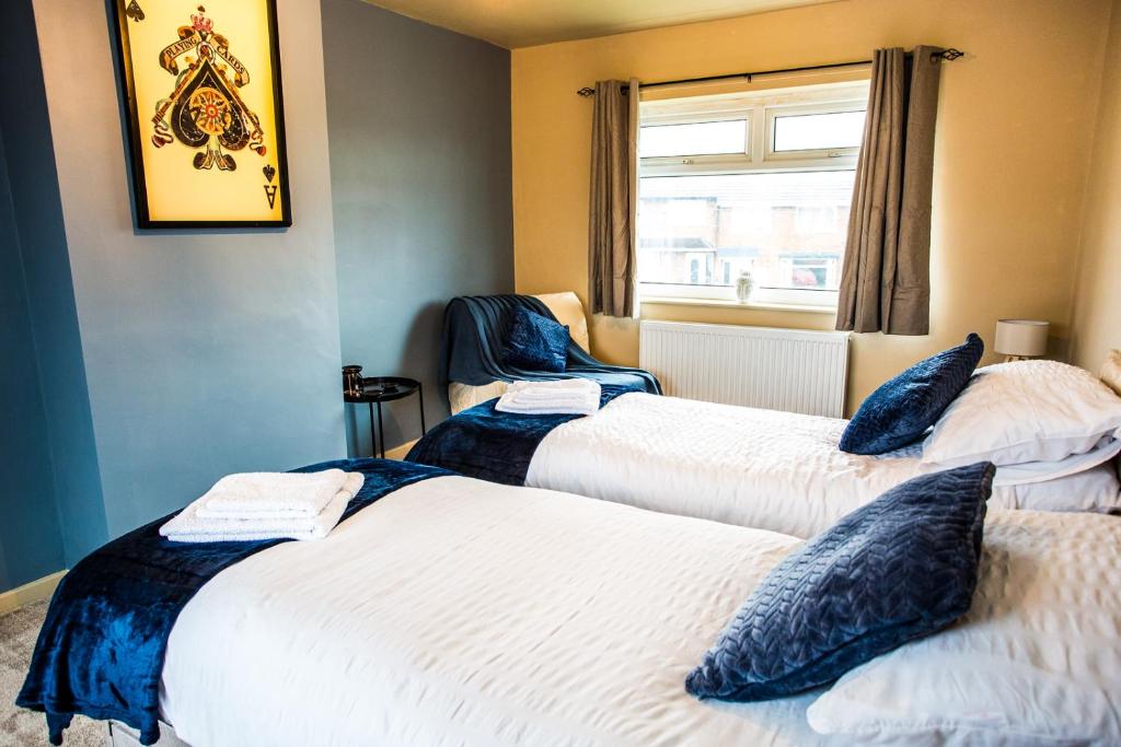 a room with two beds and a window at Contractor accom, sleeps 7, free wifi in Stockton-on-Tees