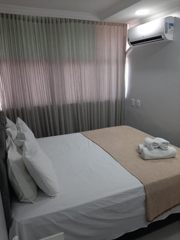 a bedroom with a bed with two towels on it at Apartamento 2010 in Goiânia