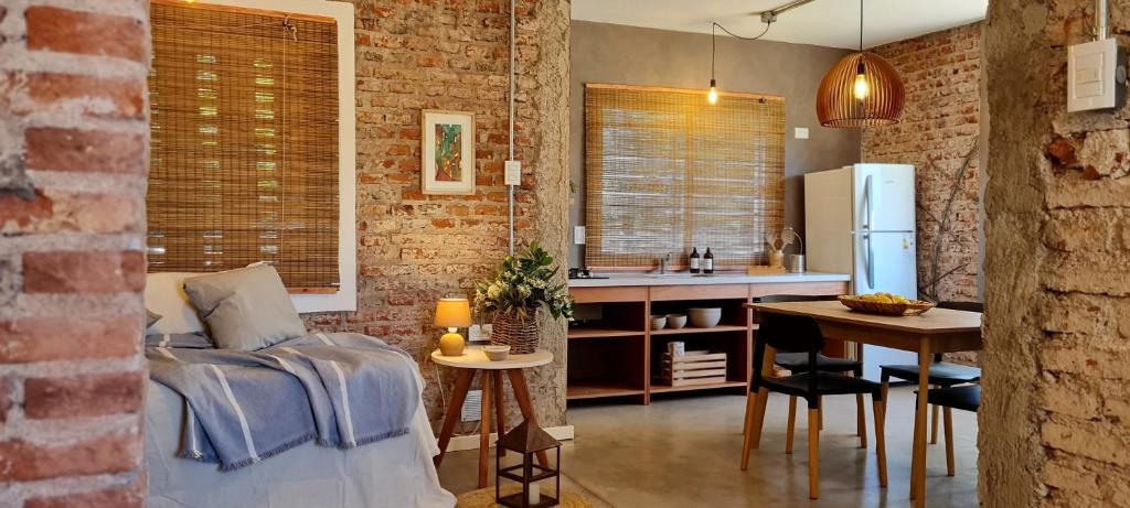 a kitchen and living room with a couch and a table at Casas Urbanas Apart Hotel in Jesús María