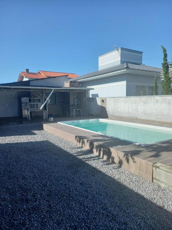 a swimming pool in the backyard of a house at Casa de praia in Palhoça