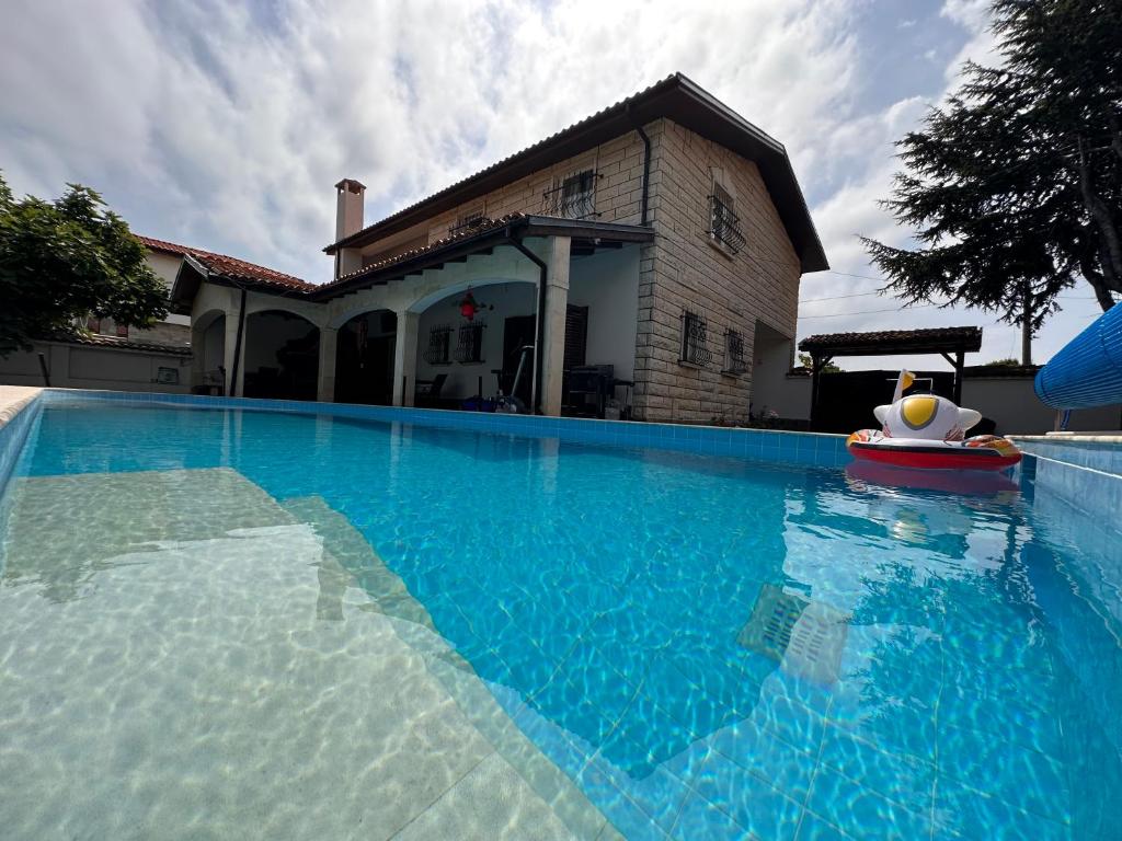 a large swimming pool in front of a house at Family House FreeДом in Sinemorets