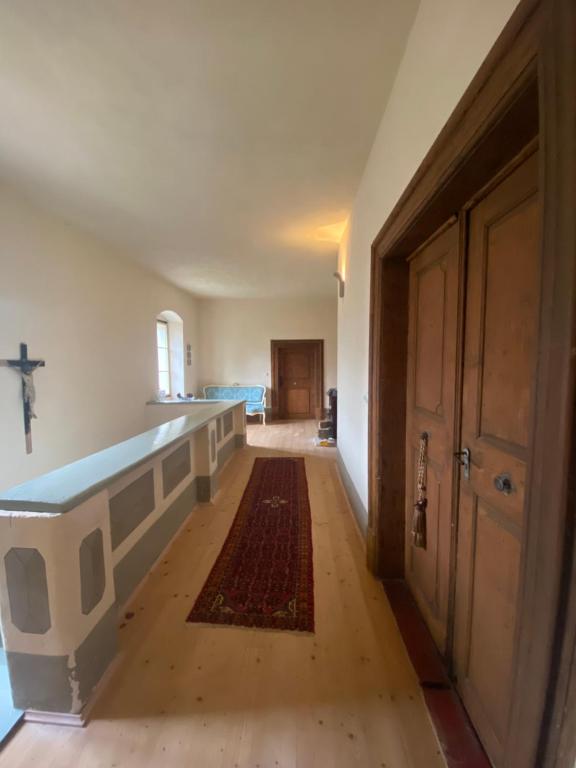 an empty room with a large bath tub and a hallway at Magical suite in a historical rectory house 