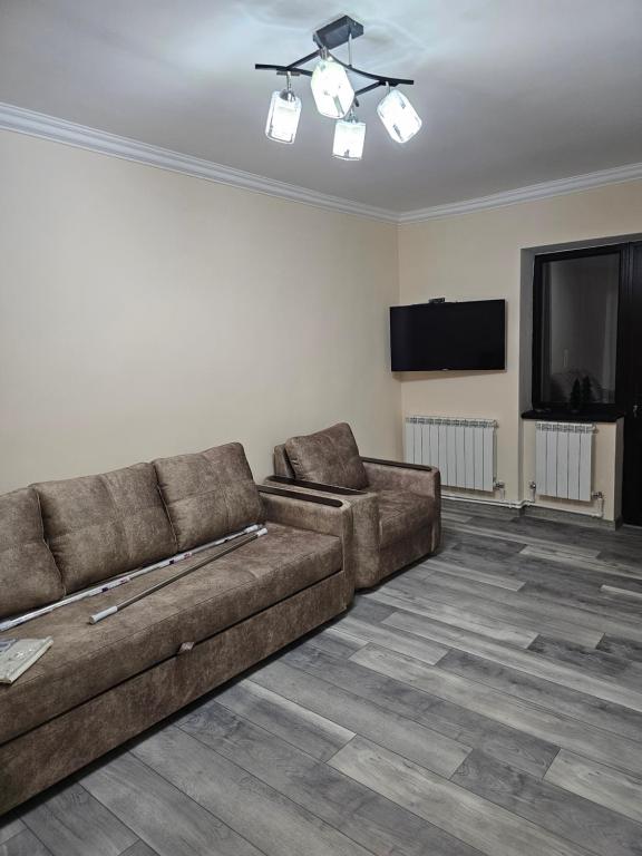 a living room with a couch and a flat screen tv at Квартира отдыха in Ijevan