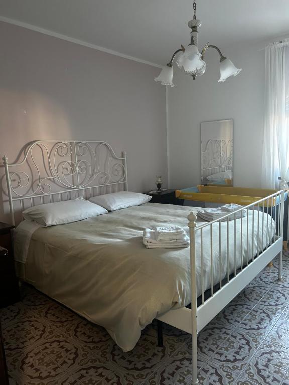 a bedroom with a bed with a white bed frame at Casa Tatone in Roccaraso