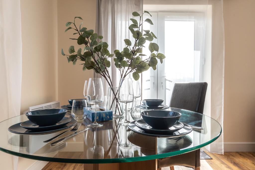 a glass dining room table with a vase on it at Apartment with free P for Van. in Southampton