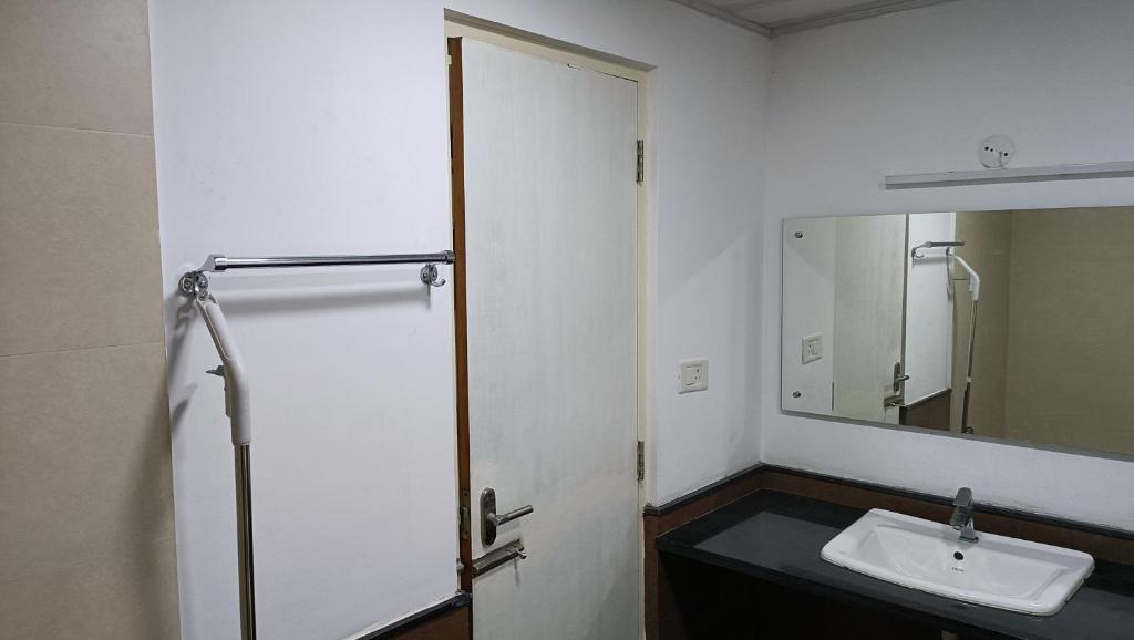 a bathroom with a sink and a mirror at Safa Serviced Apartments in Cochin