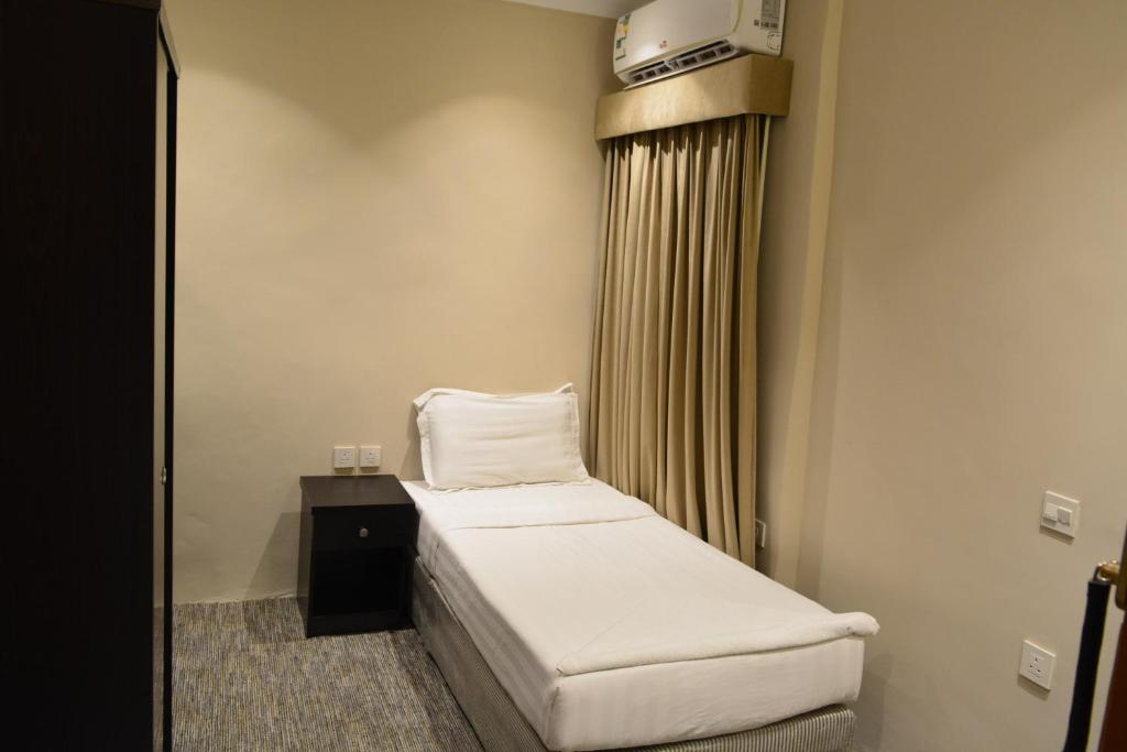 Postel nebo postele na pokoji v ubytování فندق كنان العزيزية Kinan Al Azizia Hotel Makkah