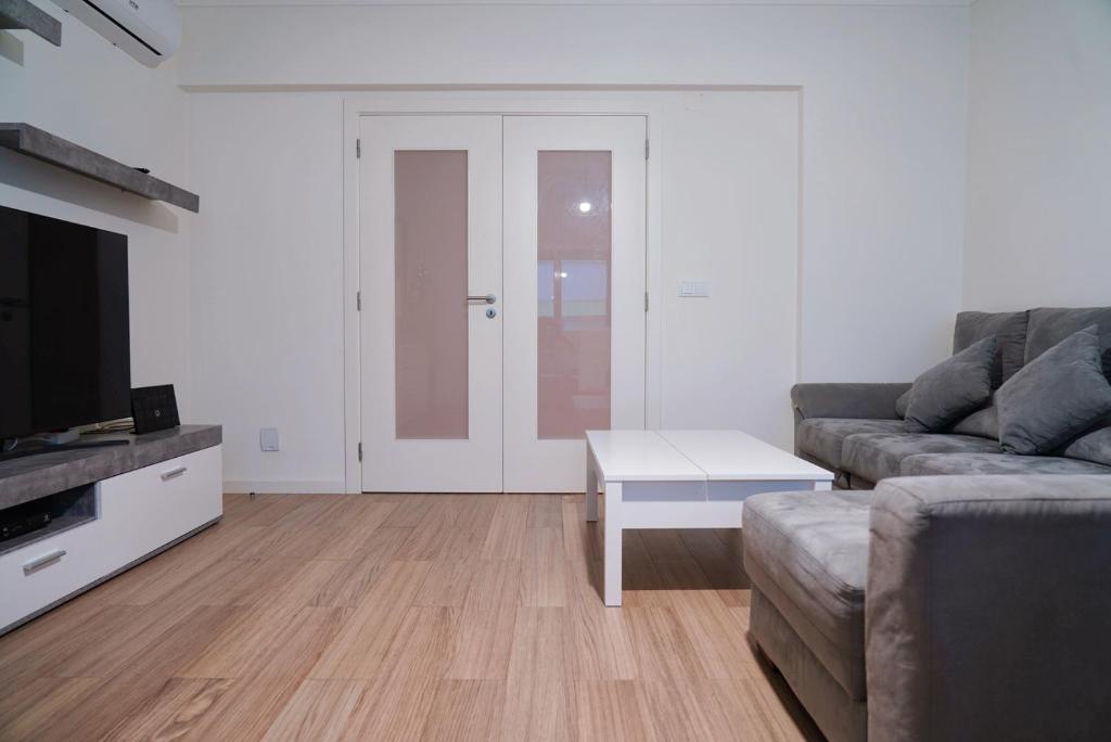 a living room with a couch and a coffee table at Always on the way - Road Home in Montijo, Lisbon in Montijo