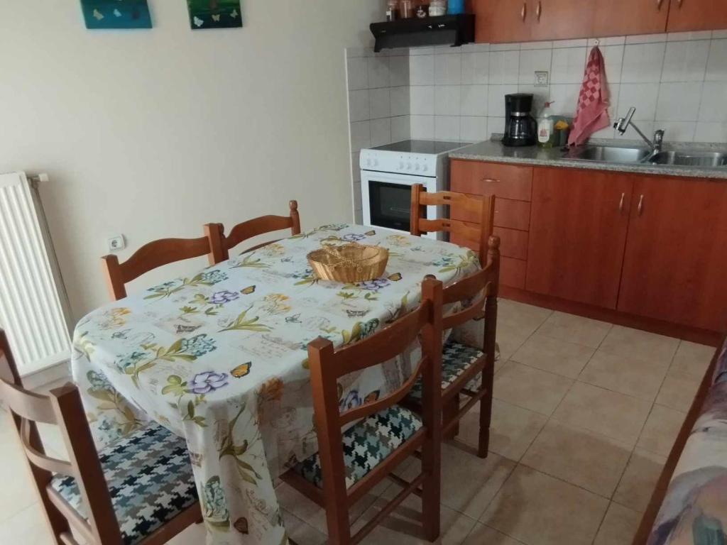 a kitchen with a table and some chairs and a table and a table at THREE BROTHERS in Dhidhimótikhon