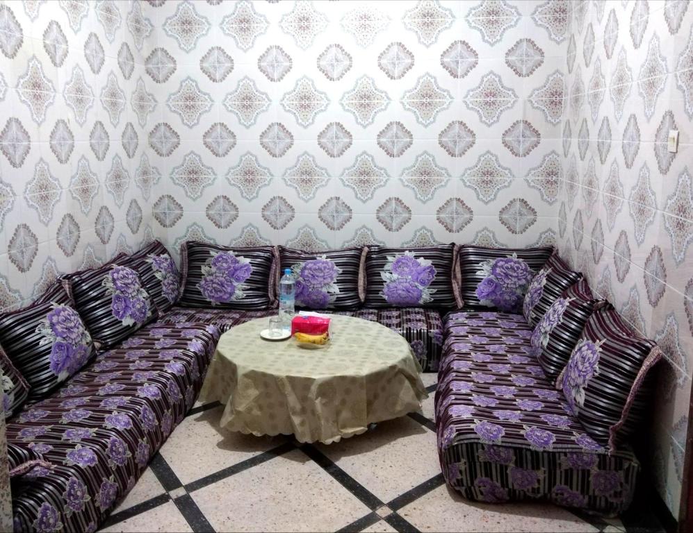 a living room with a couch and a table at Aziz House 1 in Tan-Tan