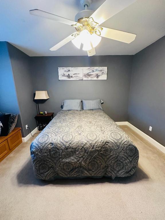 a bedroom with a bed and a ceiling fan at serenity in Fresno
