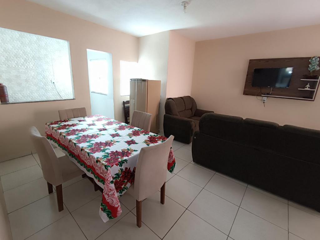 a living room with a table and a couch at pousada Montanhez ap5 in Alto Caparao