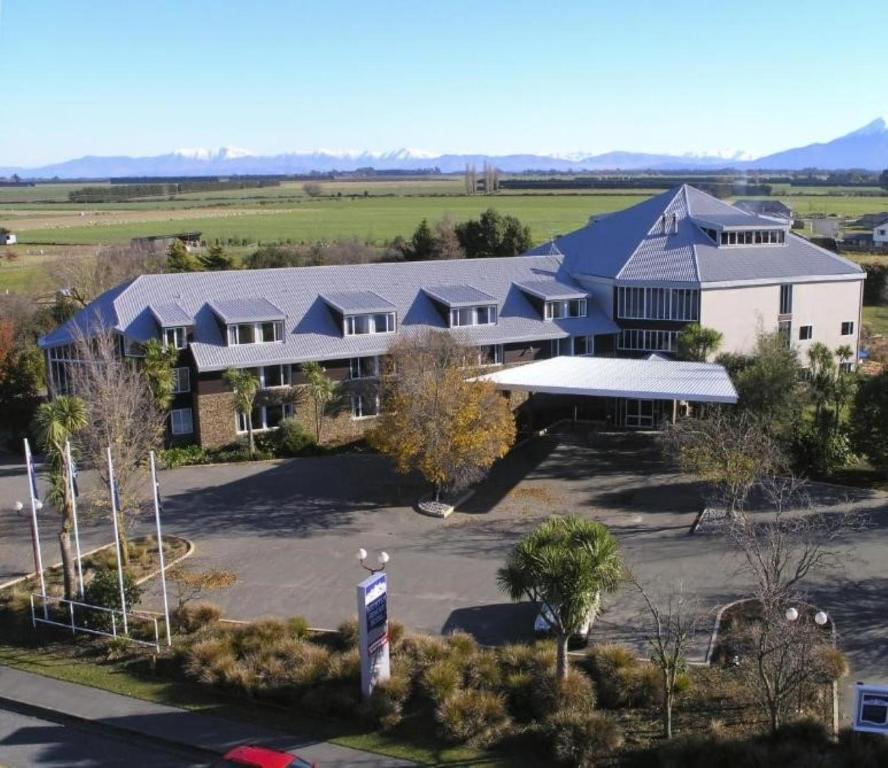 an aerial view of a building with a parking lot at Methven Resort in Methven