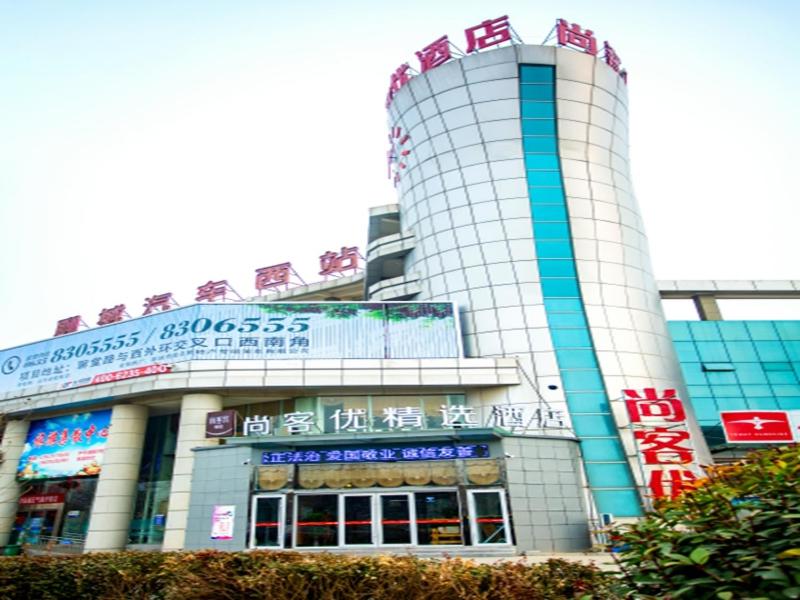 a building with signs on top of it at Thank Inn Plus Hotel Shandong Liaocheng Railway Station in Liaocheng
