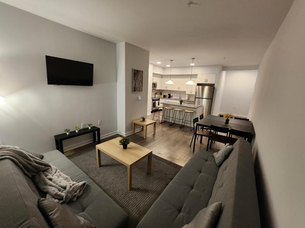 a living room with a couch and a table at Stylish Modern 2BR Mins to NYC! in Jersey City