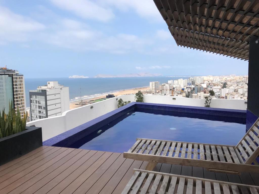 a swimming pool on the roof of a building at Albano, Ocean view and pool near Miraflores and airport in Lima