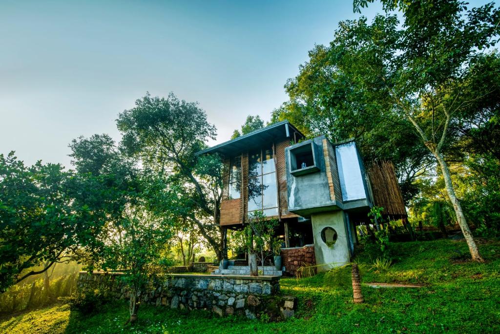 a tree house in the middle of a field at Heavens Acres Lodge - Two Bed Room Cabana - Agarloom in Matale