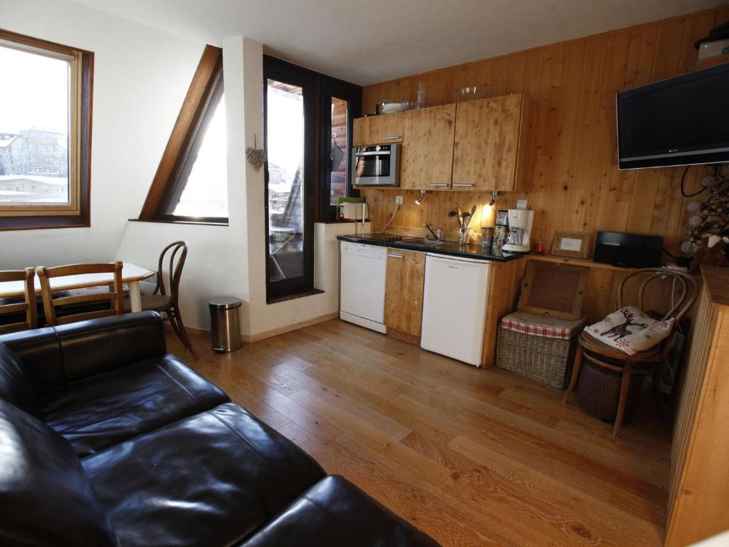 a living room with a couch and a kitchen at Appartement Avoriaz, 2 pièces, 4 personnes - FR-1-314-269 in Morzine