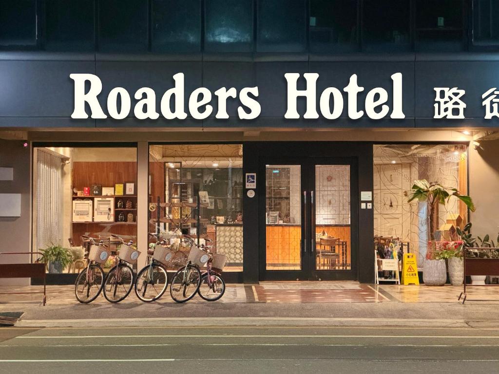 a couple of bikes parked outside of a hotel at Roaders Hotel Tainan ChengDa in Tainan