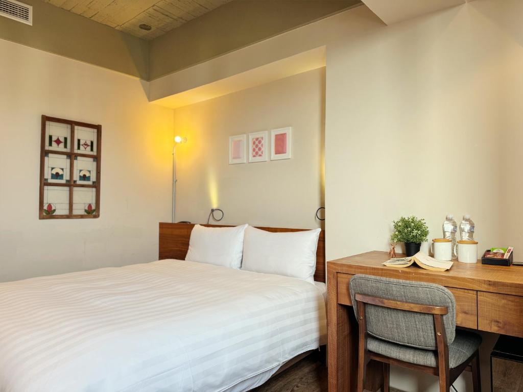 Postel nebo postele na pokoji v ubytování Roaders Hotel Tainan ChengDa
