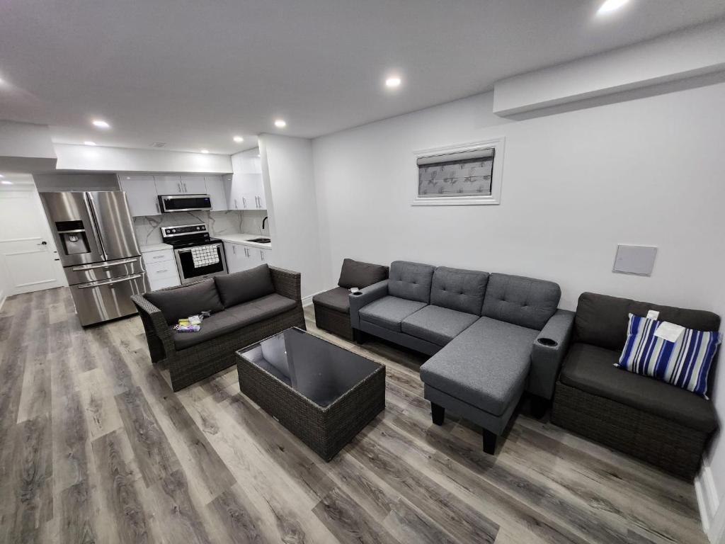 ein Wohnzimmer mit 2 Sofas und einer Küche in der Unterkunft New Modern room in Innisfil in Innisfil