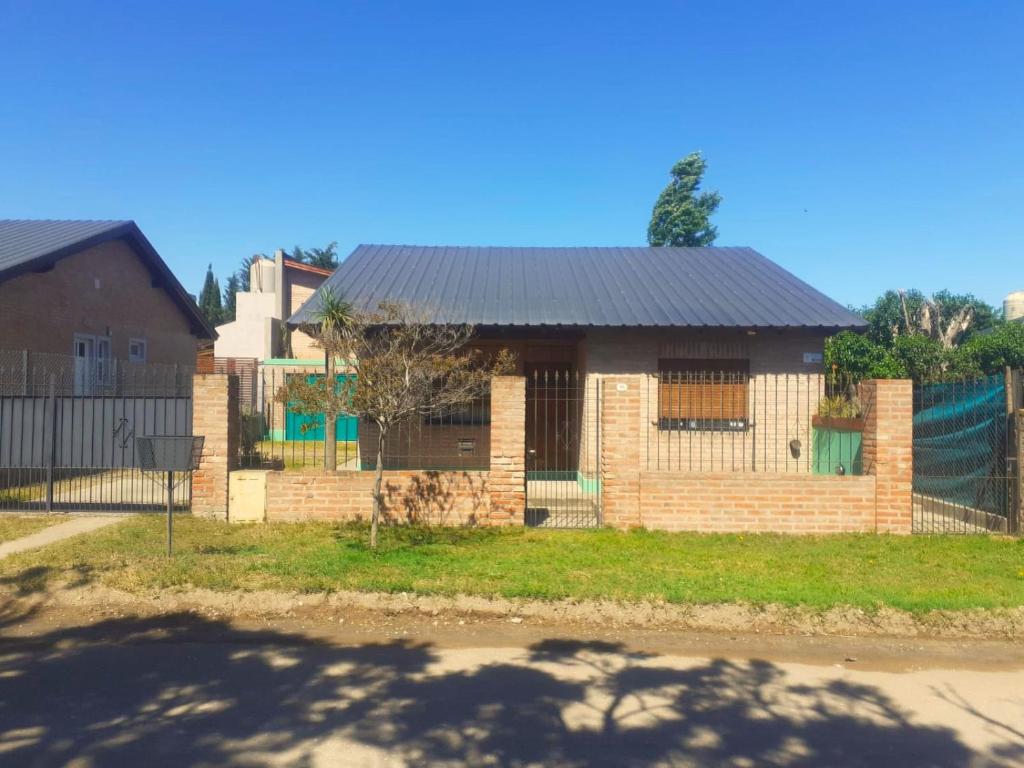 a brick house with a black roof at Casa Monte Hermoso del Este in Monte Hermoso