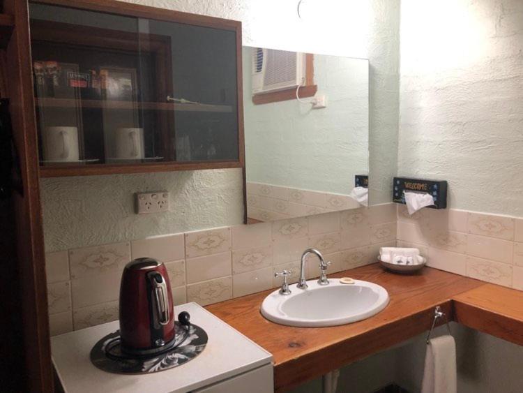 a kitchen with a sink and a toaster on a counter at Olde Horsham Motor Inn in Horsham