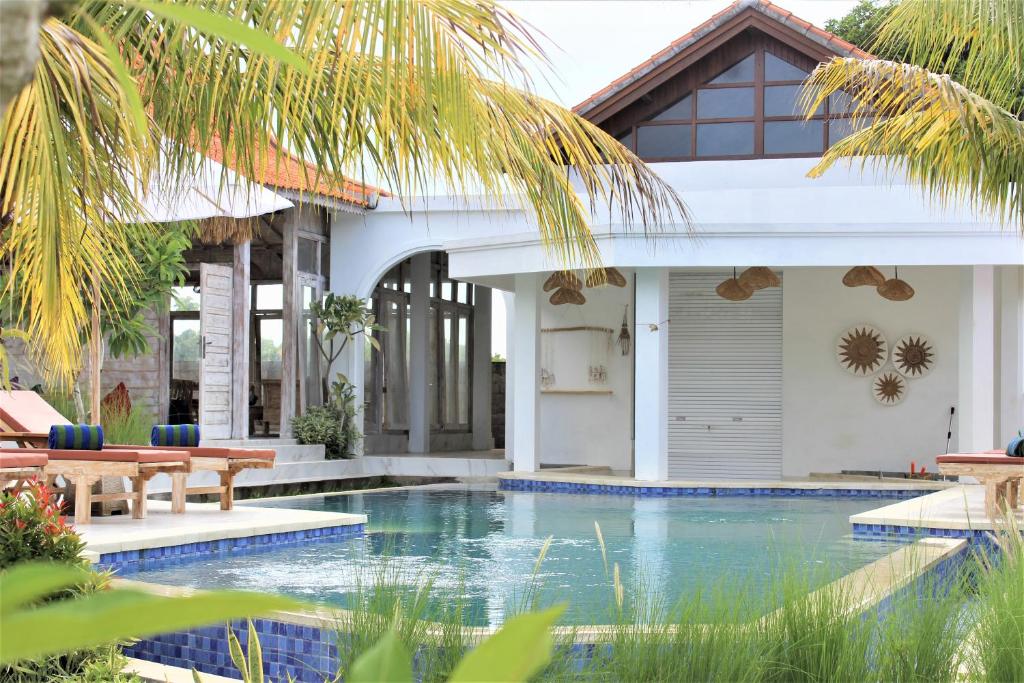 a house with a swimming pool in front of a house at Green Village Jungle Resort in Nusa Penida